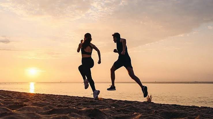 running couple on beach